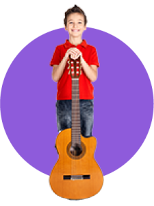 A boy standing with his hands on an upright guitar