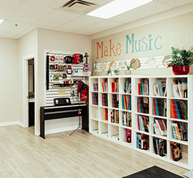 A music room with white book shelves