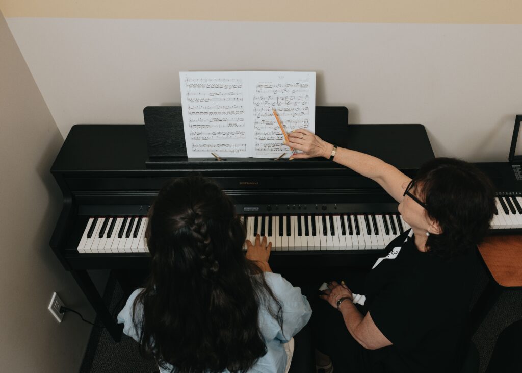 Music teacher helping student focus during piano lesson at The Piano Studio
