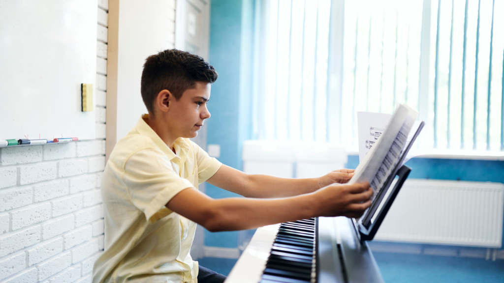 Teenage boy at piano demonstrating how to find time to practise piano through a focused after-school routine
