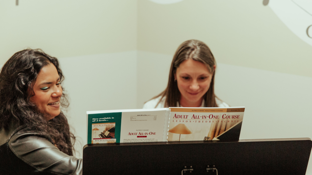 Adult student learning piano with a teacher during adult music lessons in Newmarket